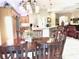 Eat-in kitchen with a wood dining table, matching chairs, and an open view to the kitchen at 2850 Apache Ct, The Villages, FL 32163