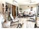 Relaxing Florida room with comfortable seating, sliding glass doors, and tile flooring at 2850 Apache Ct, The Villages, FL 32163