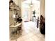 Inviting foyer with tile flooring, decorative shelving, and natural light at 2850 Apache Ct, The Villages, FL 32163