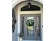 Welcoming front entryway with a decorative glass door and a festive wreath at 2850 Apache Ct, The Villages, FL 32163
