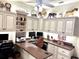 Spacious home office with built-in desk, ample storage, and dual workstations at 2850 Apache Ct, The Villages, FL 32163