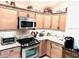 Modern kitchen featuring stainless steel appliances, granite countertops, and ample cabinetry at 2850 Apache Ct, The Villages, FL 32163