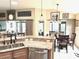 Spacious kitchen with granite countertops, stainless steel appliances, and dining area at 2850 Apache Ct, The Villages, FL 32163