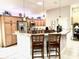 Modern kitchen with granite countertops, stainless steel appliances, and a breakfast bar at 2850 Apache Ct, The Villages, FL 32163