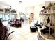 Open living room with tile floors, comfortable seating, and views into the kitchen at 2850 Apache Ct, The Villages, FL 32163