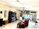 Comfortable living room with a large entertainment center, leather furniture, and tile floors at 2850 Apache Ct, The Villages, FL 32163