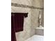 Tile shower with bench, handheld showerhead, and grab bars at 2850 Apache Ct, The Villages, FL 32163