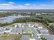 Aerial view of a new residential community showcasing homes and a tranquil lake at 33571 Sky Blossom Cir, Leesburg, FL 34788