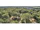 Aerial view showing home nestled in a wooded area at 34620 Galla Rd, Fruitland Park, FL 34731