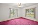 Bedroom with carpet, ceiling fan and large windows at 34620 Galla Rd, Fruitland Park, FL 34731