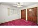Bedroom with wood closet doors and purple carpet at 34620 Galla Rd, Fruitland Park, FL 34731