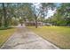 Long driveway leading to a ranch-style house at 34620 Galla Rd, Fruitland Park, FL 34731