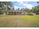 Brick ranch house with attached two-car garage and spacious lawn at 34620 Galla Rd, Fruitland Park, FL 34731