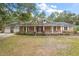 Brick ranch house with attached two-car garage and large yard at 34620 Galla Rd, Fruitland Park, FL 34731