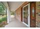 Brick home with covered porch and white columns at 34620 Galla Rd, Fruitland Park, FL 34731