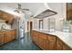 Kitchen with wood cabinets, stainless steel appliances, and tile floor at 34620 Galla Rd, Fruitland Park, FL 34731