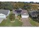 Aerial view of a single-Gathering home with a solar panel system and landscaped yard at 3550 Auburndale Ave, The Villages, FL 32162