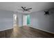 Spacious bedroom with ceiling fan and wood-look floors at 3550 Auburndale Ave, The Villages, FL 32162