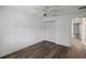 Bedroom with double door closet and wood floors at 3550 Auburndale Ave, The Villages, FL 32162