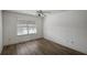 Bright bedroom with wood-look floors and window at 3550 Auburndale Ave, The Villages, FL 32162