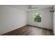 Simple bedroom with wood-look floors and window at 3550 Auburndale Ave, The Villages, FL 32162