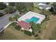 Community pool with a pergola, lounge chairs, and adjacent building at 3550 Auburndale Ave, The Villages, FL 32162