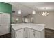 Kitchen island with white cabinets and quartz countertop, offering extra prep space at 3550 Auburndale Ave, The Villages, FL 32162