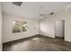 Living room featuring wood-look floors and access to a bathroom at 3550 Auburndale Ave, The Villages, FL 32162