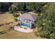 Aerial view showcasing house, pool, and lush landscape at 39320 Harbor Hills Blvd, Lady Lake, FL 32159