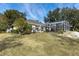 Spacious backyard with patio and screened enclosure at 39320 Harbor Hills Blvd, Lady Lake, FL 32159