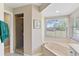 Bathroom with a shower and a garden tub at 39320 Harbor Hills Blvd, Lady Lake, FL 32159