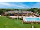 Community center with pool, lounge area, and adjacent golf course at 39320 Harbor Hills Blvd, Lady Lake, FL 32159