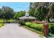 Community entrance with gatehouse, lush landscaping, and welcoming curb appeal at 39320 Harbor Hills Blvd, Lady Lake, FL 32159