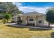 View of the house's side showcasing a well-maintained lawn at 39320 Harbor Hills Blvd, Lady Lake, FL 32159