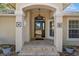 Elegant front door with a covered entryway and brick flooring at 39320 Harbor Hills Blvd, Lady Lake, FL 32159