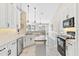 Modern kitchen with white cabinets, stainless steel appliances and breakfast bar at 39320 Harbor Hills Blvd, Lady Lake, FL 32159