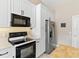 Bright kitchen with white cabinets, stainless steel appliances, and granite countertops at 39320 Harbor Hills Blvd, Lady Lake, FL 32159