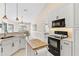 Bright kitchen with white cabinets, stainless steel appliances, and breakfast bar at 39320 Harbor Hills Blvd, Lady Lake, FL 32159