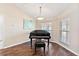 Sunlit room with a grand piano and wood flooring at 39320 Harbor Hills Blvd, Lady Lake, FL 32159