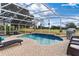 Inviting screened pool area with lounge chairs at 39320 Harbor Hills Blvd, Lady Lake, FL 32159