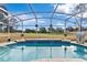 Inviting screened pool with golf course views at 39320 Harbor Hills Blvd, Lady Lake, FL 32159