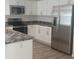 Updated kitchen featuring stainless steel appliances, white cabinetry, and sleek countertops at 439 Woodview Dr, Tavares, FL 32778