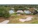 Aerial view showcasing the home's location on a golf course with a pool at 5509 Grove Mnr, Lady Lake, FL 32159