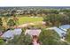 An aerial view of the home, pool, and the golf course community at 5509 Grove Mnr, Lady Lake, FL 32159