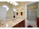 Bathroom with tile flooring, cherry cabinets, and a walk-in shower at 5509 Grove Mnr, Lady Lake, FL 32159