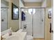 Bathroom with a glass shower, white sink, and wood-look tile floor at 5509 Grove Mnr, Lady Lake, FL 32159