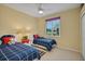 Bedroom with two twin beds, plantation shutters, and carpeted floors at 5509 Grove Mnr, Lady Lake, FL 32159