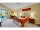 Comfortable bedroom with access to the patio and pool area at 5509 Grove Mnr, Lady Lake, FL 32159