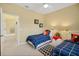 Twin bedroom with blue and white bedding and a walk-in closet at 5509 Grove Mnr, Lady Lake, FL 32159