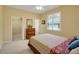 Bedroom featuring a floral comforter, wood dresser, and plantation shutters at 5509 Grove Mnr, Lady Lake, FL 32159